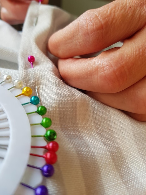 hands embroidering fabric close up